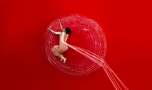 woman's body in performance against red background. APT