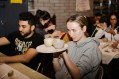 Girl in grey sweatshirt in pottery workshop.