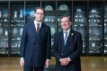 Two men dressed in suits, standing in front of museum case of ceramics. British Museum