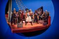 The cast of 'The Pirates of Penzance' aboard a ship, with rigging.