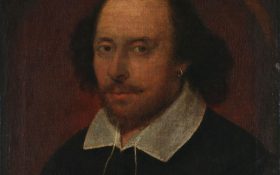 John Taylor, 'Chandos portrait', 1610, showing as part of 'Writers Revealed' at HOTA. An oil painting rendered in dark hues of a figure looking calmly at the viewer.